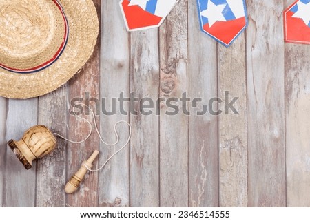 Fiestas Patrias Chile September 18, Independence Day. Air view. Sombrero huaso chupallas de paja y emboque, on a wooden table with flag. copy space. Chilenidad Royalty-Free Stock Photo #2346514555