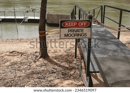 red, black and white Keep Off, Private Moorings sign at a gangway entry point