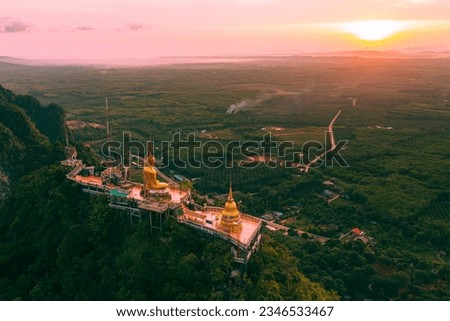 Beautiful aerial drone view of buddha statue on top of the mountain at sunrise, Wat Tham Sua (Seua) or (Tiger Cave Temple), Krabi, Thailand. Royalty-Free Stock Photo #2346533467