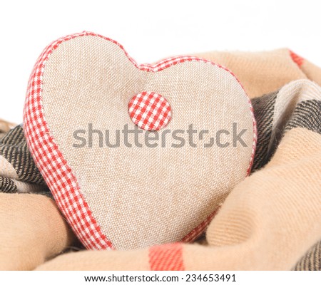Fabric linen handmade heart on a warm scarf  on white background
