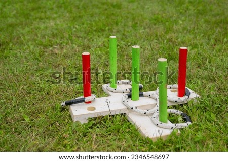 Kids ring tossing game on a fresh green lawn in summer during sports games. Isolated Royalty-Free Stock Photo #2346548697