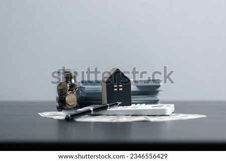 Loan application form paper with money coin and loan house model on table, Loan business finance economy commercial real estate investments. Home loan concept. Royalty-Free Stock Photo #2346556429