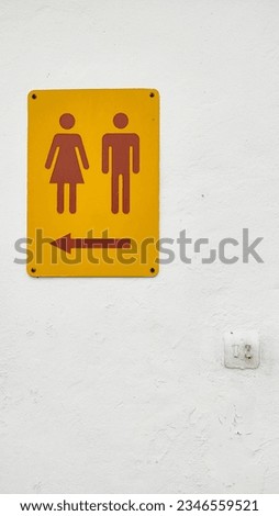 Male and female sign on white wall