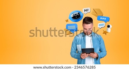Smiling man looking at tablet in hands, digital robot icon with text and speech bubbles, empty orange background. Concept of AI conversation, social media and technology