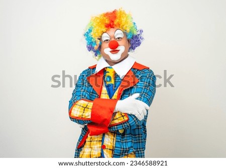 Mr Clown. Portrait of Funny face Clown man in colorful uniform standing arms crossed smiling to camera. Happy expression male bozo in various pose on isolated background.