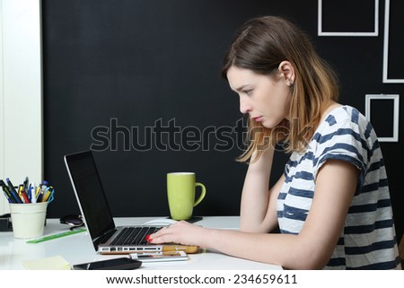 Young girl with laptop, Pretty caucasian female working in home office -  business, education or leisure concept
