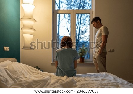 Upset woman and man in difficult period of life. Domestic quarrels crisis in relationship difficult stage in marriage, sad husband and wife after argument. Concept of Shattered Romantic Relationships Royalty-Free Stock Photo #2346597057