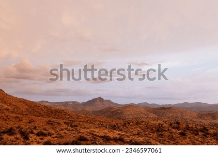 A beautiful sunset landscape with hills, mountains and scenic sky in orange tones. A scenic landscape at sunset. Phoenix, AZ, USA
