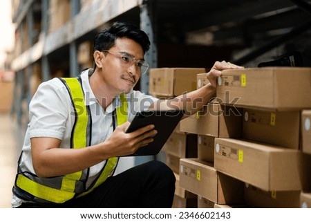 Logistics and export business concept. warehouse manager uses a tablet computer to inspect goods in a warehouse. 
