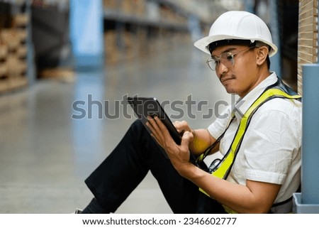 Male warehouse worker sitting in a warehouse. industrial concept warehouse.
