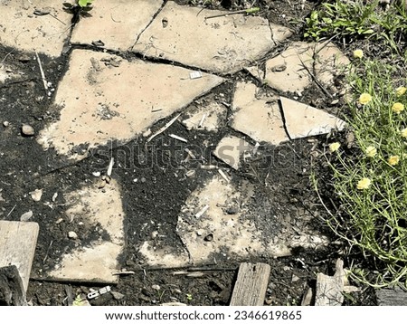 a photography of a broken sidewalk with a broken sidewalk sign, a close up of a broken sidewalk with a broken sidewalk.