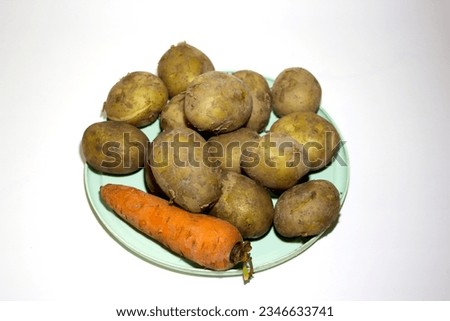 Boiled potatoes and carrots in a plate on a white background. Isolated