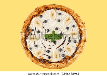 appetizing sweet kids pizza with banana and blueberries on yellow background, studio shot 2