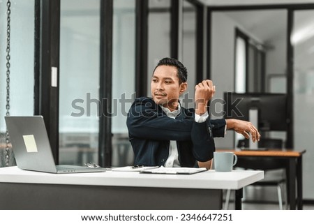 Asian real estate broker or legislation lawyer businessman straightening at office work desk.