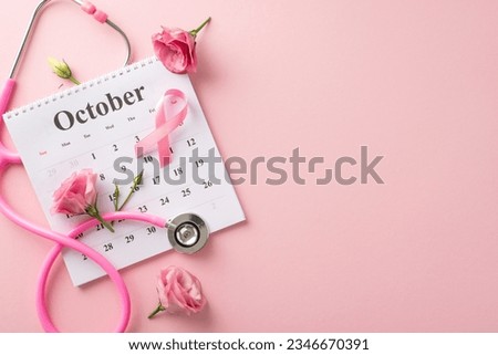 October's Pink Ribbon Campaign is here. Top view of calendar and pink ribbon, stethoscope and eustoma flowers on pastel pink isolated background, perfect for text or advertising placement