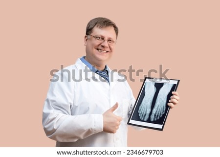 The doctor examines the X-ray picture, doctor blond 40-44 years old. Royalty-Free Stock Photo #2346679703