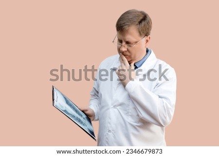 The doctor examines the X-ray picture doctor blond 40-44 years old, Royalty-Free Stock Photo #2346679873