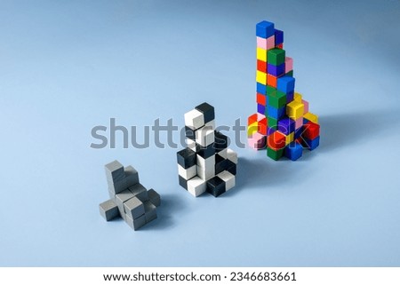 Diversity concept. Three pyramids of gray, black and white and multicolored cubes.