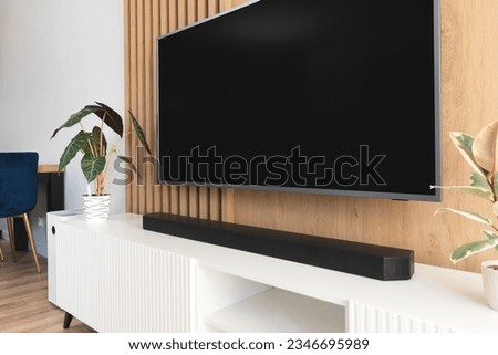 Soundbar in a modern home. Listening to music in living room Royalty-Free Stock Photo #2346695989