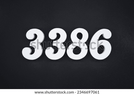 Black for the background. The number 3386 is made of white painted wood.