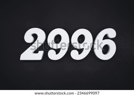 Black for the background. The number 2996 is made of white painted wood.