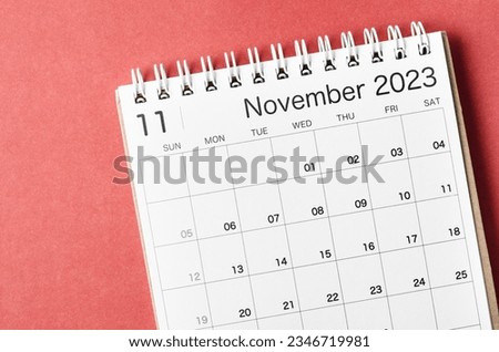November 2023 calendar desk for the organizer to plan and reminder isolated on red background.