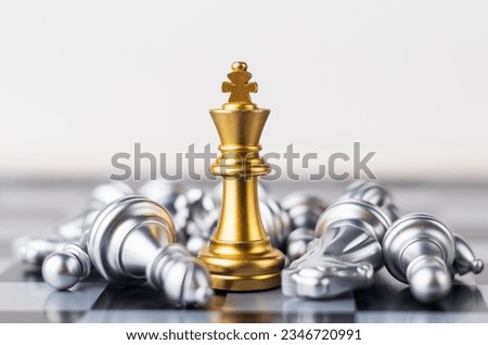Leader, business strategy and planning concept, Gold Chess king figure on Chessboard and surrounded by a number of fallen silver chess pieces against opponent or enemy. Conflict, tactic, politic. Royalty-Free Stock Photo #2346720991