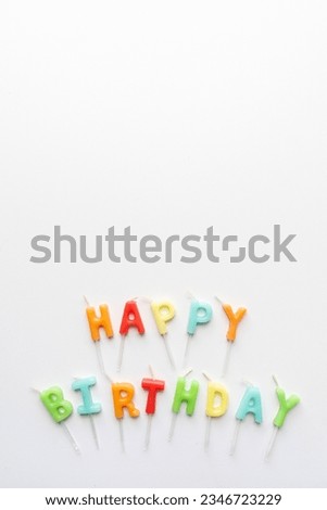 The words happy birthday formed with candle letters isolated over white with copy space. Vertical shot.