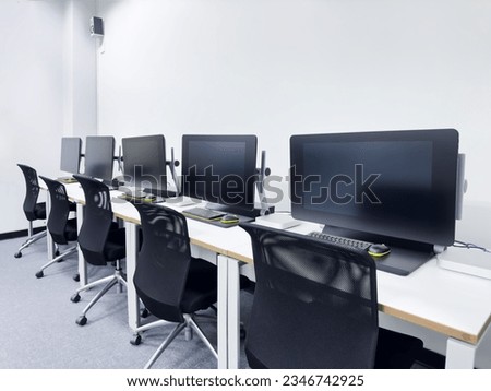 Photo of computer row on table at the computer lab.