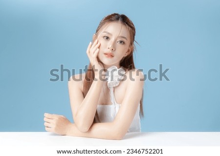 Young Asian beauty woman model long hair with natural makeup look on face and perfect clean skin on isolated blue background. Facial treatment, Cosmetology, Spa, Aesthetic, plastic surgery. Royalty-Free Stock Photo #2346752201
