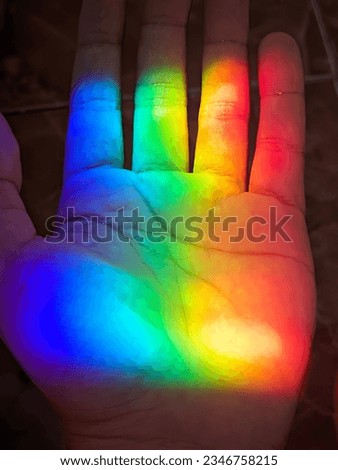 close up of a palm with rainbow highlights
