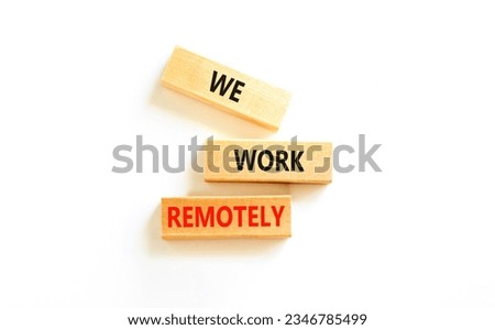 We work remotely symbol. Concept words We work remotely on wooden block. Beautiful white table white background. Business we work remotely concept. Copy space.