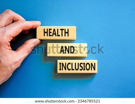 Health and inclusion symbol. Concept words Health and inclusion on wooden block. Beautiful blue table blue background. Doctor hand. Business motivational health and inclusion concept. Copy space.