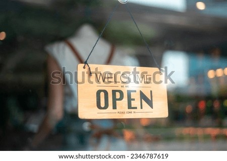 Woman entrepreneur with Open sign in cafe shop , small business concept 