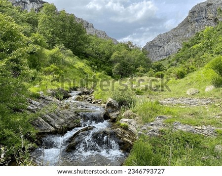Beautiful landscape in north of Spain. Green nature with the river and sky whit clouds, is the perfect mountain photo. Relaxing and calm photo.