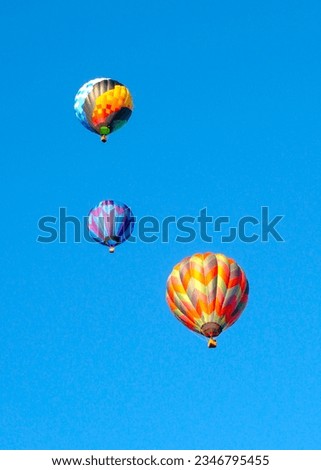 Colorful three hot air balloons on blue sky. Space for text