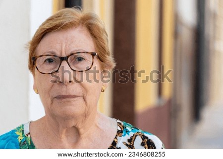 Portrait, senior woman looking serious at camera outdoors Royalty-Free Stock Photo #2346808255