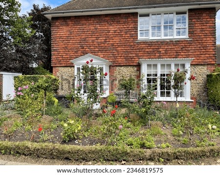 English cottage with beautiful front flower garden Royalty-Free Stock Photo #2346819575
