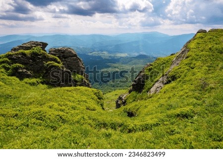 summer mountain landscape. rocks on the grassy hills. beautiful scenery on a sunny day Royalty-Free Stock Photo #2346823499