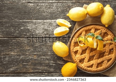 Delicious lemon pie, tart  with cooking ingredients on the wooden table