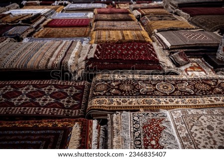 The wide range of the hand made carpets, traditional knotted Uzbek silk rugs in the small bazaar, Bukhara, Uzbekistan, Central Asia Royalty-Free Stock Photo #2346835407