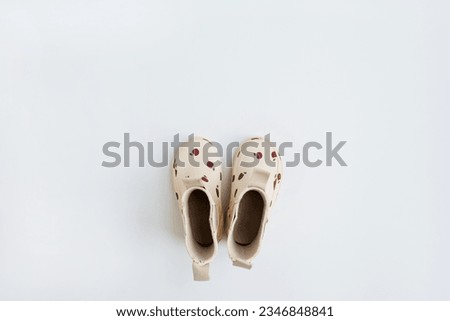 Children's rubber rain boots on white background