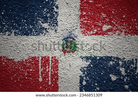 colorful painted big national flag of dominican republic on a massive old cracked wall