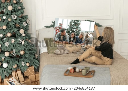 woman holding a photo canvas as a Christmas present.
