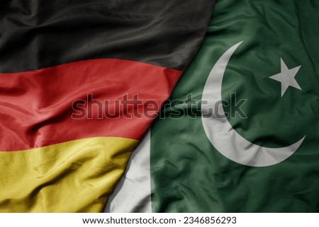 big waving realistic national colorful flag of germany and national flag of pakistan . macro