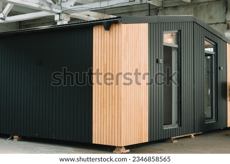 Exhibition of new and modern prefabricated modular house from composite wood panels. Energy efficient panel assembling Royalty-Free Stock Photo #2346858565