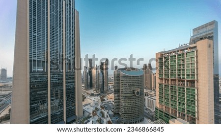 Dubai international financial center skyscrapers aerial night to day transition panoramic . Illuminated towers view from above before sunrise