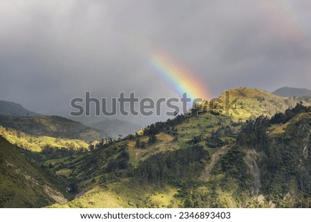Rainbow above mountains. Beautiful natural landscapes. Picturesque nature.