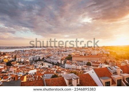 View of Lisbon famous view from Miradouro da Senhora do Monte tourist viewpoint of Alfama and Mauraria old city district, 25th of April Bridge at sunset. Lisbon, Portugal Royalty-Free Stock Photo #2346895383