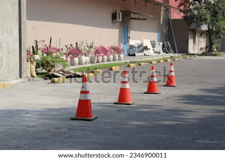 orange traffic cone barrier in car park